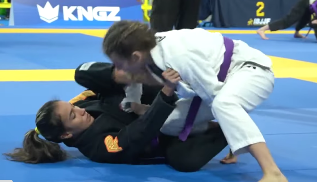 Two girls competing in jiu jitsu