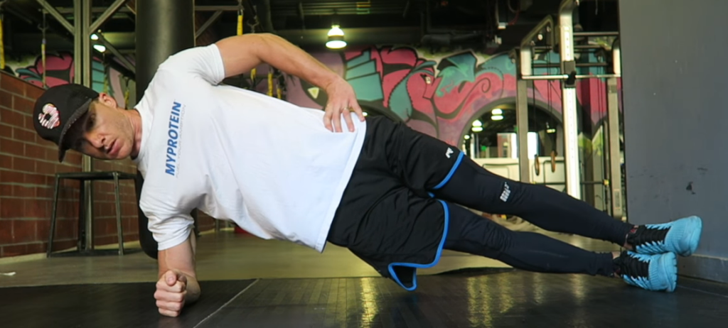 a man performing a side plank
